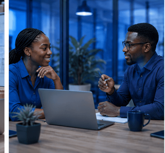 Two colleagues talking through a plan across a laptop